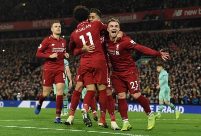 Liverpool’s Brazilian midfielder Roberto Firmino (2R) celebrates shooting from the penalty spot to score his team’s fifth goal during the English Premier League football match between Liverpool and Arsenal at Anfield in Liverpool, north west England on December 29, 2018. (Photo by Paul ELLIS / AFP)