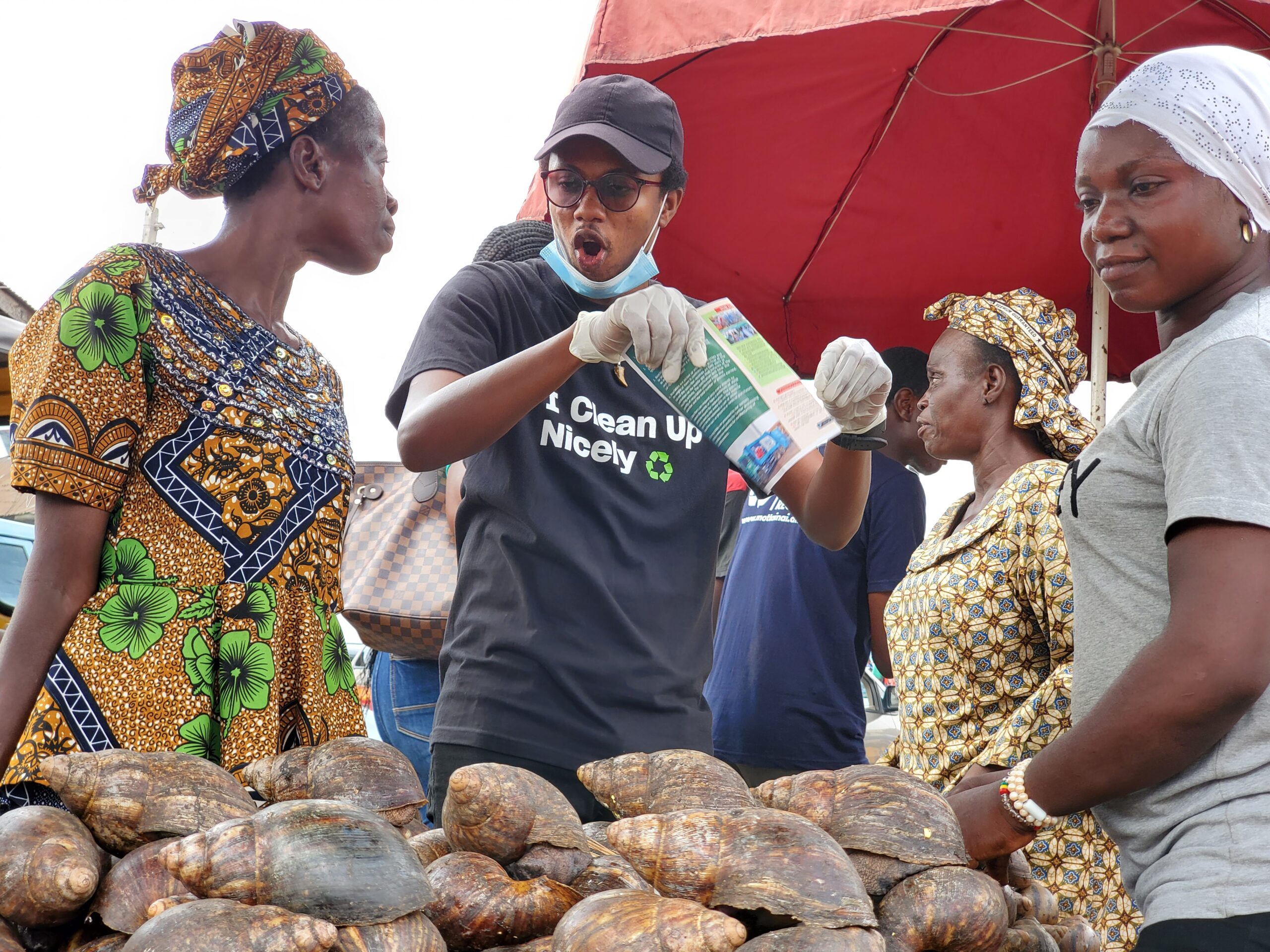 A Volunteer sensitizing a trader at Oje market earlier today