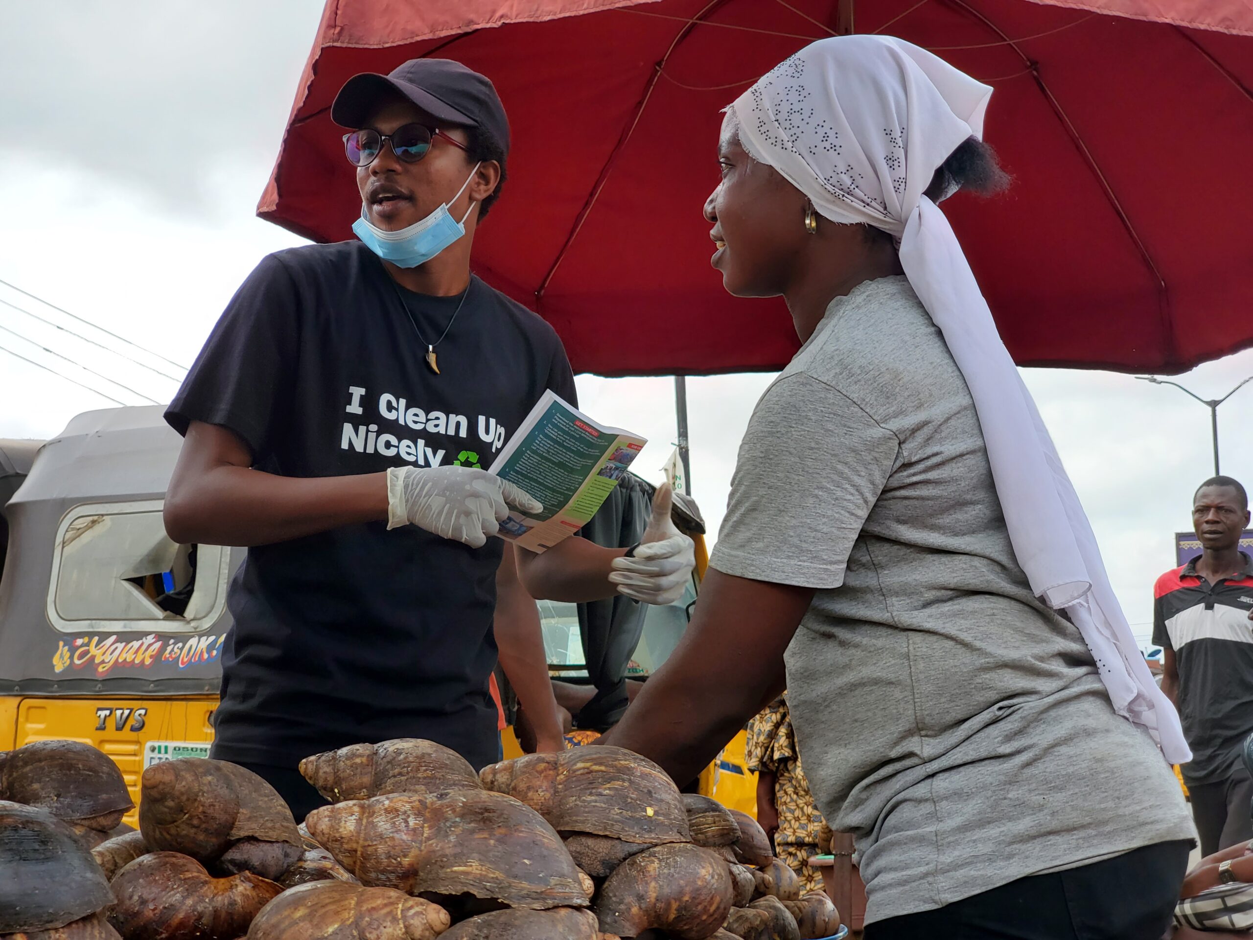 A Volunteer sensitizing a trader at Oje market earlier today